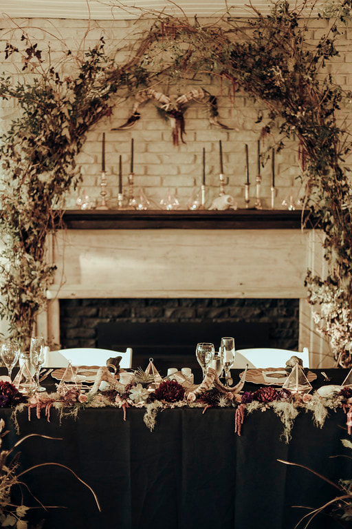 Floral backdrop behind the head table at this Kandr wedding