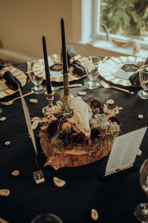 Table centerpiece with floral display around a skull